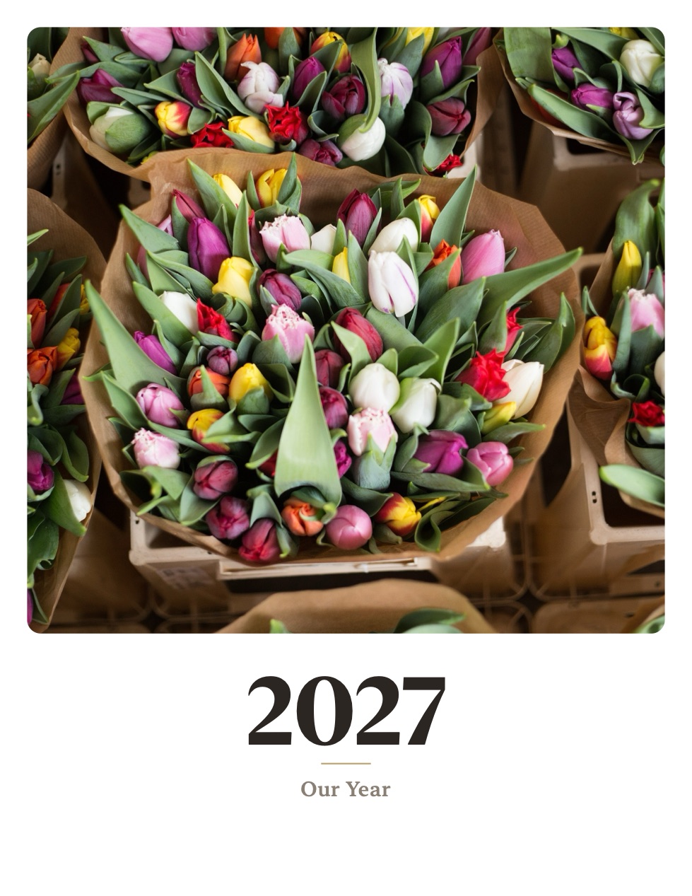 A Monthr cover page: a photograph of tulip bouquets at a flower market above the year 2027 and the title Our Year, set in a warm serif.